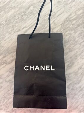 Chanel black logo matte paper gift bag + bonus eye makeup instruction booklet.